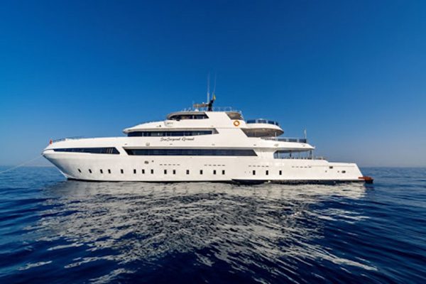 Liveaboard boat anchored near Daedalus Lighthouse, showcasing the three top liveaboard routes for diving the Deep South from Marsa Alam.